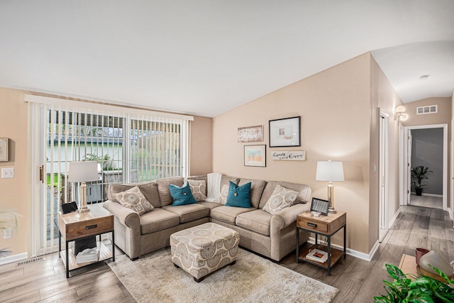 2159 Helmsford Dr, Wolverine Lake, MI 48390 - living room featuring vaulted ceiling, wood finished floors, and baseboards