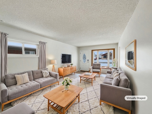 living area featuring a textured ceiling and plenty of natural light