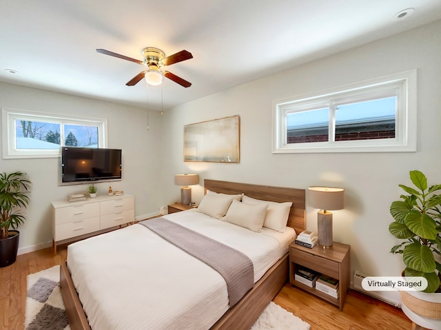 bedroom featuring baseboards, a ceiling fan, and light wood-style floors