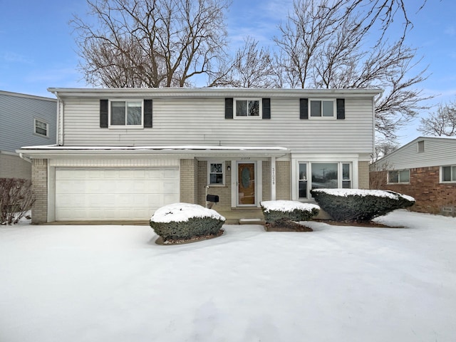 traditional-style home featuring an attached garage and brick siding