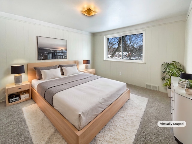 carpeted bedroom featuring visible vents