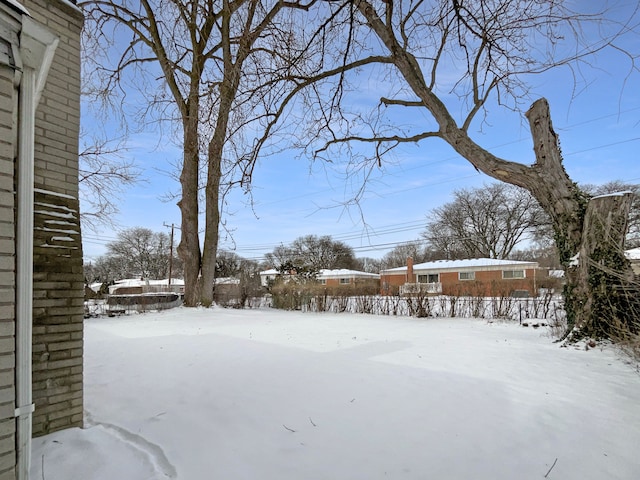 snowy yard with fence