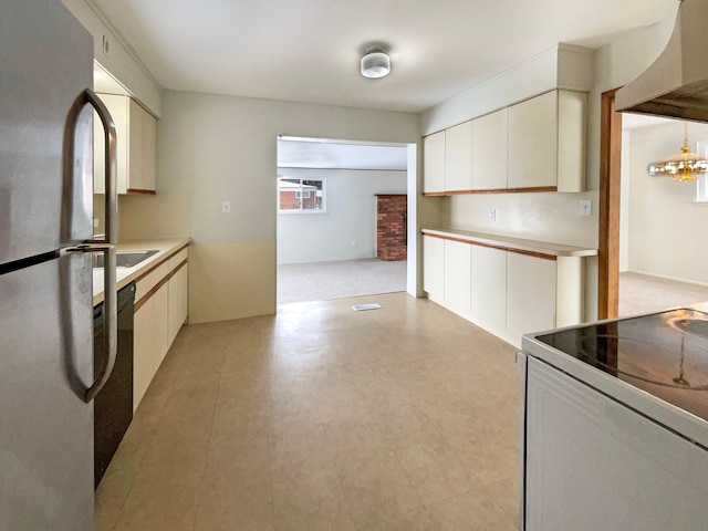 kitchen with freestanding refrigerator, white cabinets, light countertops, and white range with electric stovetop