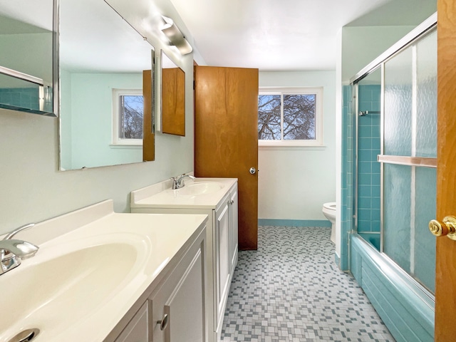 bathroom with two vanities, a sink, toilet, and tile patterned floors