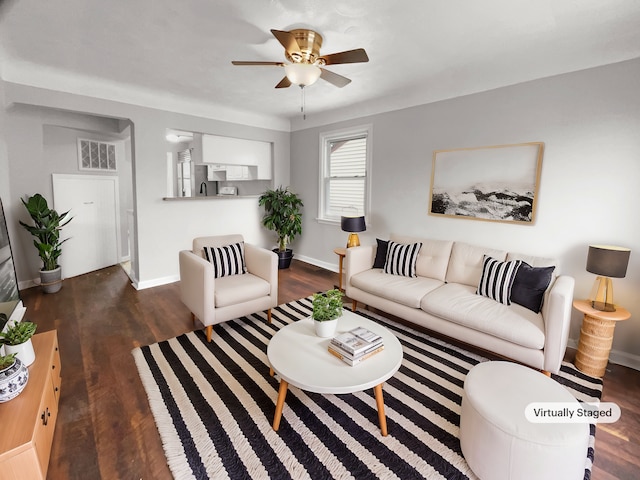 living room with a ceiling fan, baseboards, visible vents, and wood finished floors