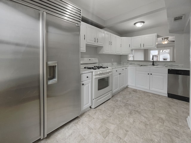 kitchen featuring a sink, visible vents, white cabinetry, light countertops, and appliances with stainless steel finishes