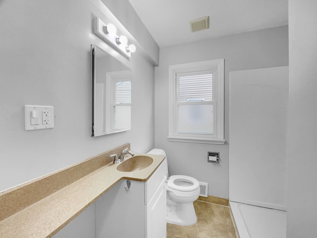 bathroom featuring visible vents, vanity, toilet, and tile patterned floors