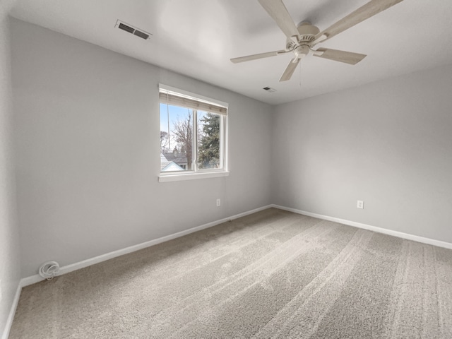 unfurnished room featuring ceiling fan, carpet floors, visible vents, and baseboards