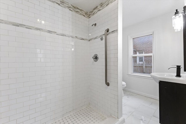 full bathroom featuring marble finish floor, toilet, a stall shower, vanity, and baseboards