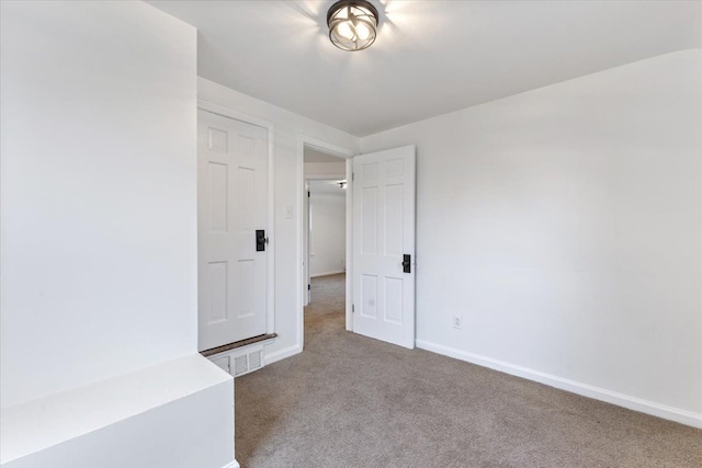 unfurnished bedroom with carpet flooring and baseboards