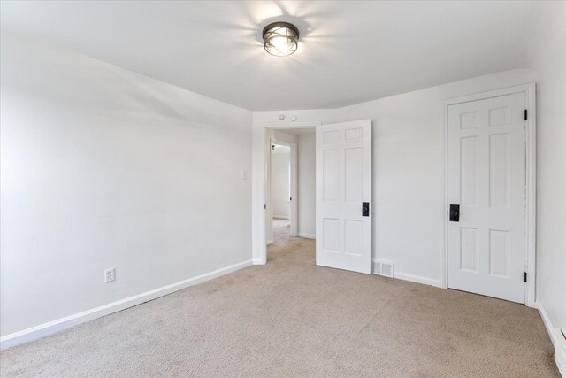 unfurnished bedroom featuring carpet flooring, visible vents, and baseboards