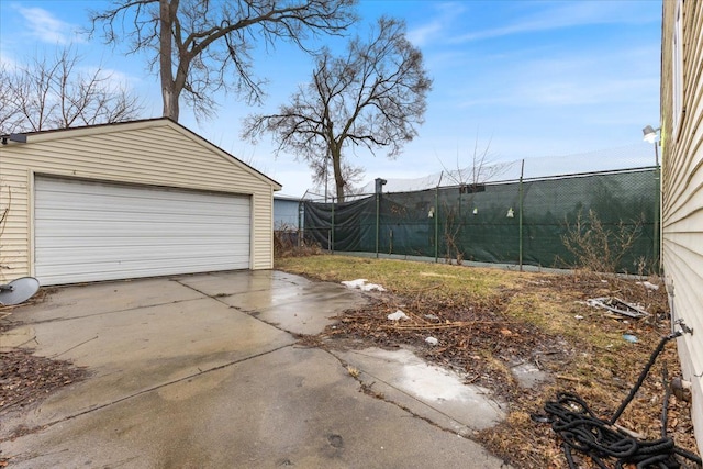 detached garage featuring fence