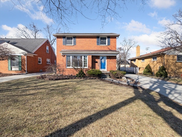 traditional-style home featuring brick siding, a front lawn, and fence