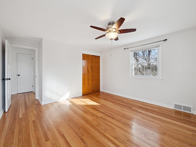 interior space with ceiling fan, visible vents, baseboards, a closet, and light wood finished floors