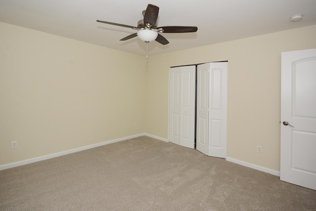 unfurnished bedroom with carpet floors, a closet, ceiling fan, and baseboards