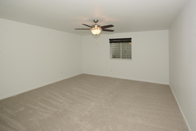 unfurnished room featuring ceiling fan, baseboards, and light colored carpet