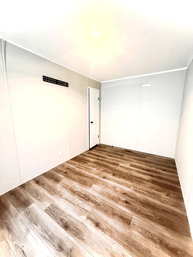 unfurnished room with wood finished floors