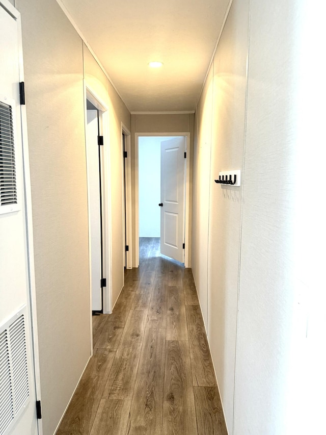 corridor featuring a heating unit and wood finished floors