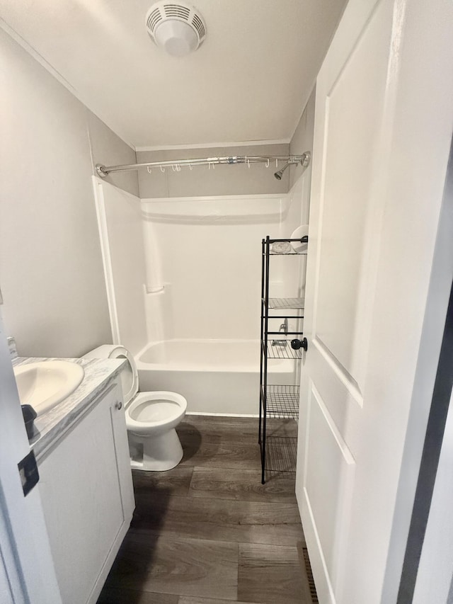 full bath featuring shower / bathtub combination, toilet, wood finished floors, visible vents, and vanity