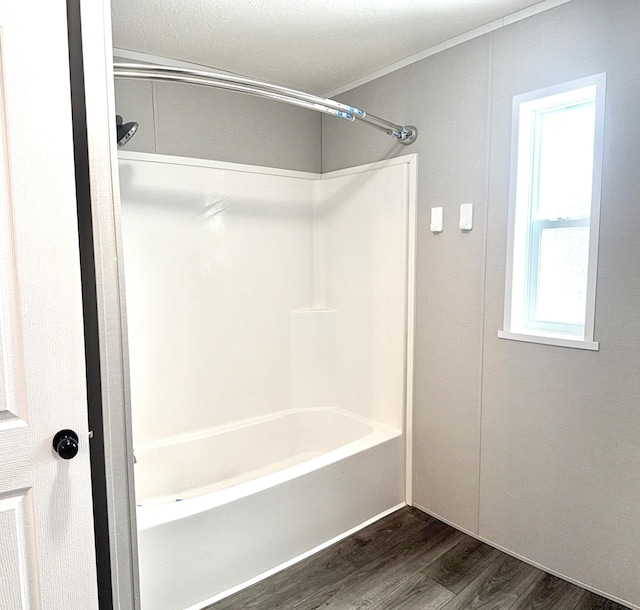 bathroom featuring tub / shower combination and wood finished floors