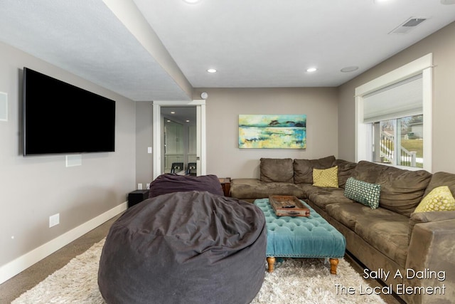 carpeted living area with baseboards, visible vents, and recessed lighting