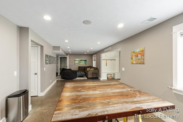 hall featuring recessed lighting, visible vents, concrete floors, and baseboards