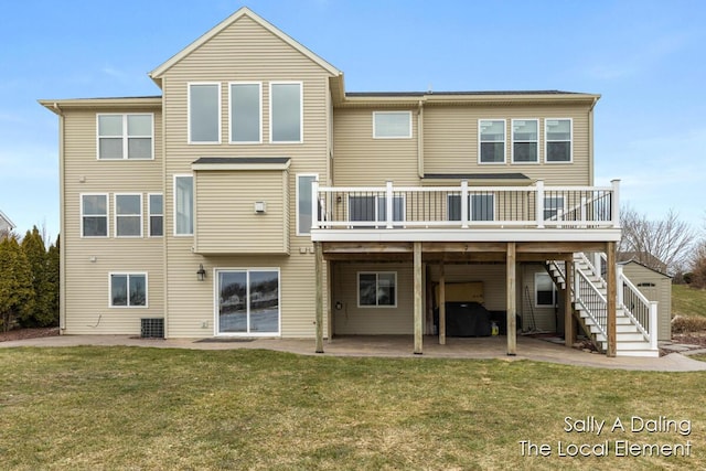 rear view of house featuring a wooden deck, stairway, a patio, and a yard