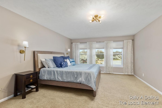 bedroom featuring carpet floors, a textured ceiling, and baseboards