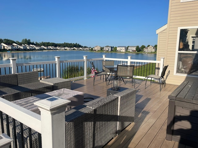 wooden terrace featuring a water view