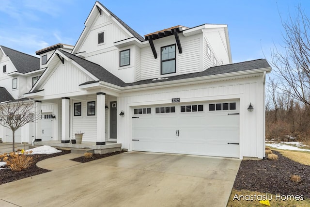 modern inspired farmhouse with board and batten siding, covered porch, concrete driveway, and roof with shingles