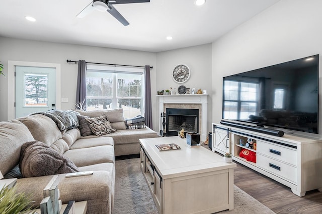 living room with a ceiling fan, recessed lighting, a fireplace, and wood finished floors