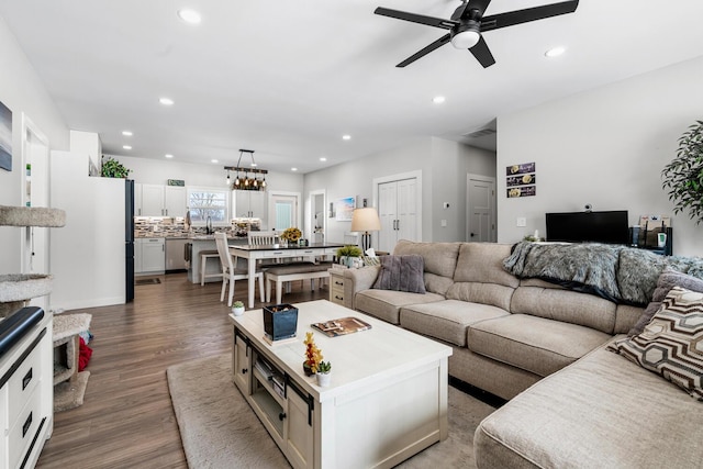 living area featuring visible vents, a ceiling fan, wood finished floors, and recessed lighting