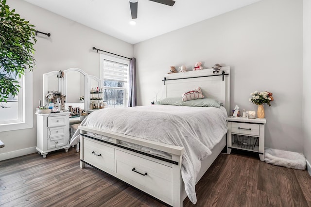 bedroom featuring ceiling fan, baseboards, and dark wood-style flooring