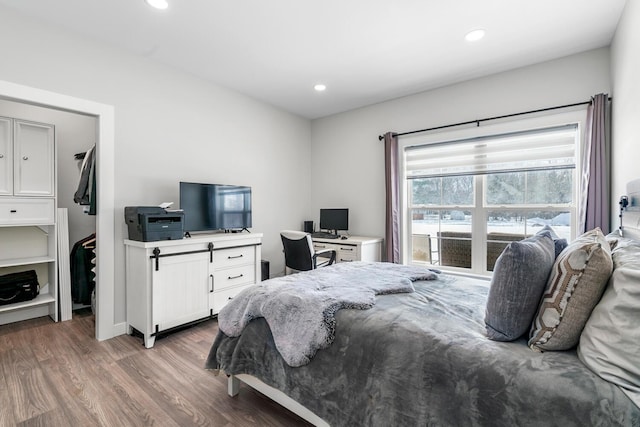 bedroom with recessed lighting and wood finished floors