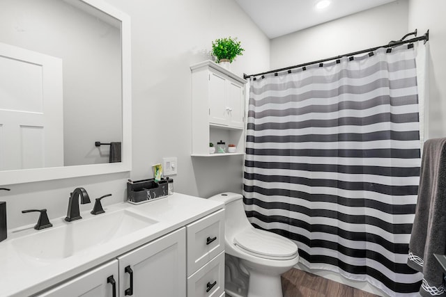 full bath with toilet, curtained shower, wood finished floors, and vanity