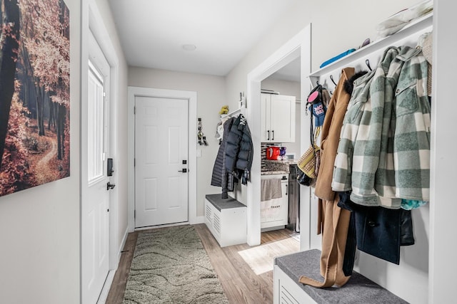 mudroom with light wood-type flooring and baseboards