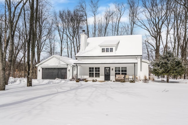 view of front of house with a garage and a chimney