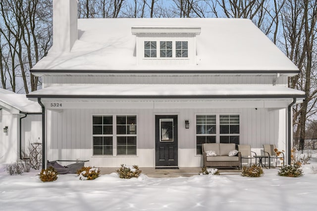 modern farmhouse featuring a porch and an outdoor living space