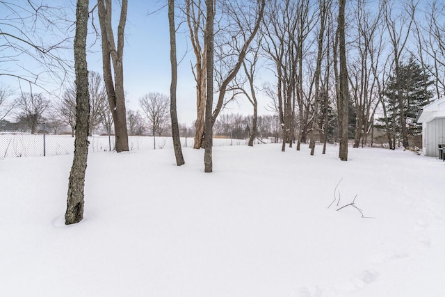 yard covered in snow with fence