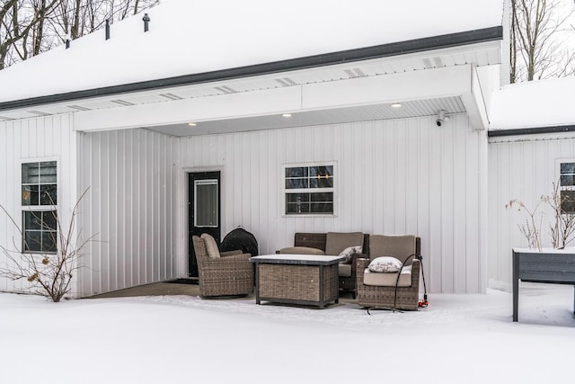 snow covered patio with an outdoor hangout area