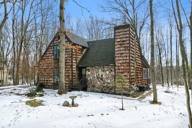 exterior space featuring stone siding and central AC