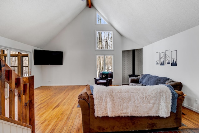 living room featuring high vaulted ceiling, wood-type flooring, and baseboards