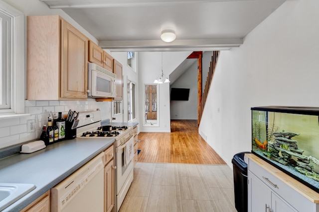 kitchen with pendant lighting, a notable chandelier, backsplash, lofted ceiling with beams, and white appliances