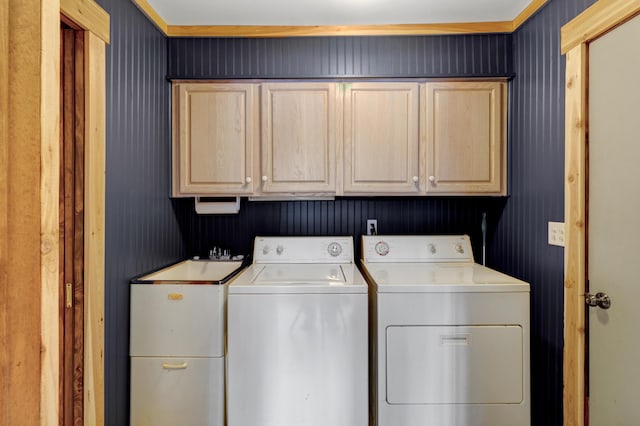 washroom with cabinet space and washer and dryer