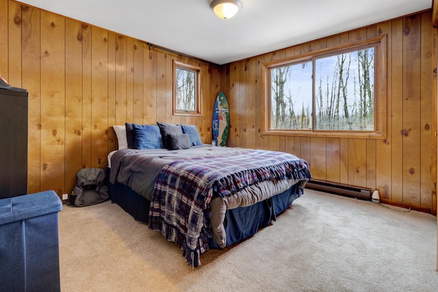 carpeted bedroom with wooden walls and a baseboard heating unit