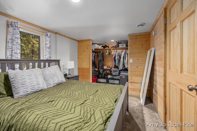 carpeted bedroom with ornamental molding and a closet