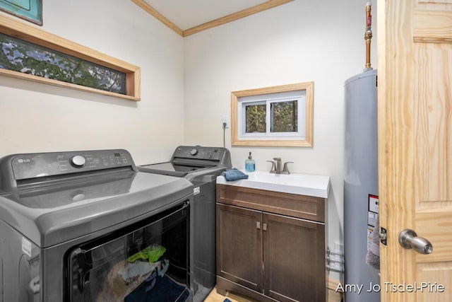 washroom with crown molding, washer and clothes dryer, water heater, cabinet space, and a sink