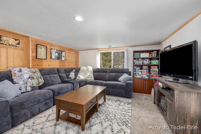 living room featuring light carpet, wood walls, and ornamental molding