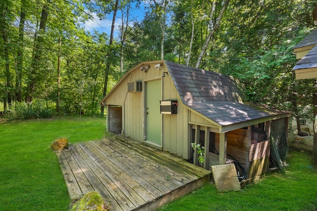 view of outdoor structure featuring an outbuilding and a wall mounted air conditioner