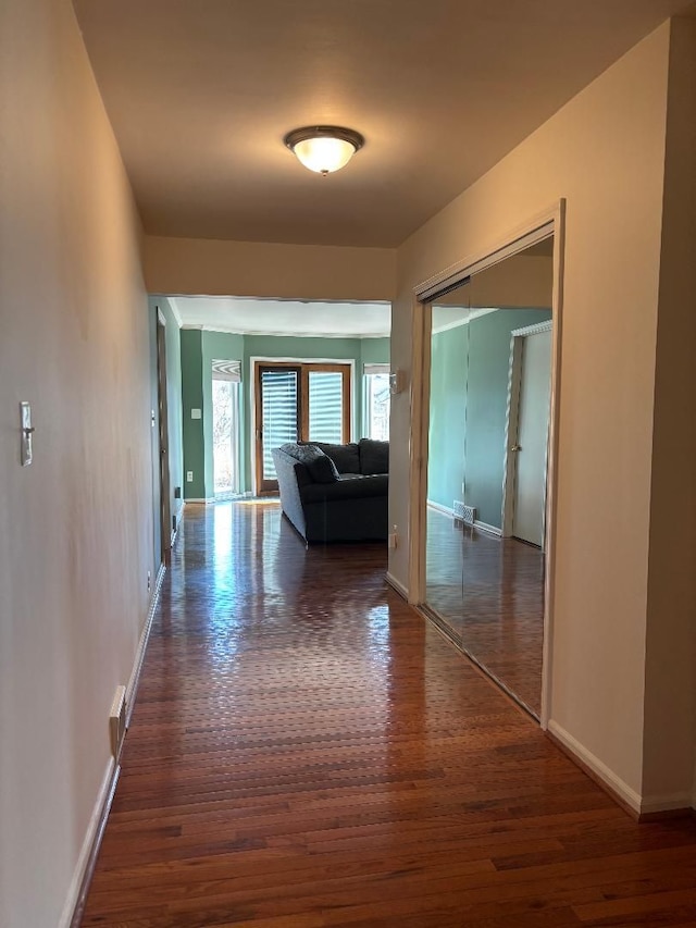 hall with wood finished floors and baseboards